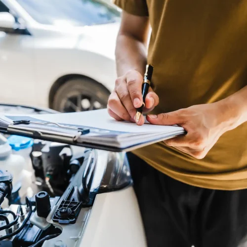 man-fills-out-a-car-insurance-form-after-a-car-acc-2024-07-02-19-51-14-utc (1)